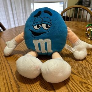Blue M&M plush.  Approximately 15” tall.